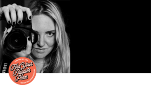 Photographer Jacqui DePas Schlosser stands behind a camera