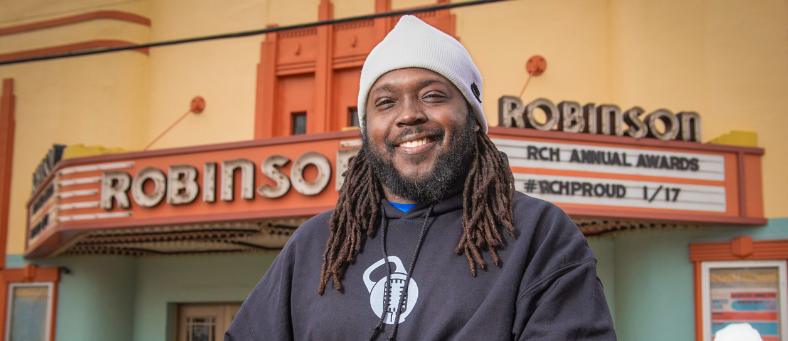 A Black business owner stands in front of Robinson Theater in Richmond