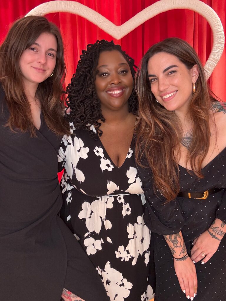 Three women local business owners in Richmond VA pose with a heart behind them