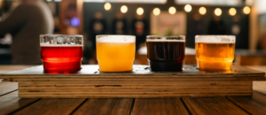 A flight of craft beers in Richmond Virginia on a patio with bistro lights